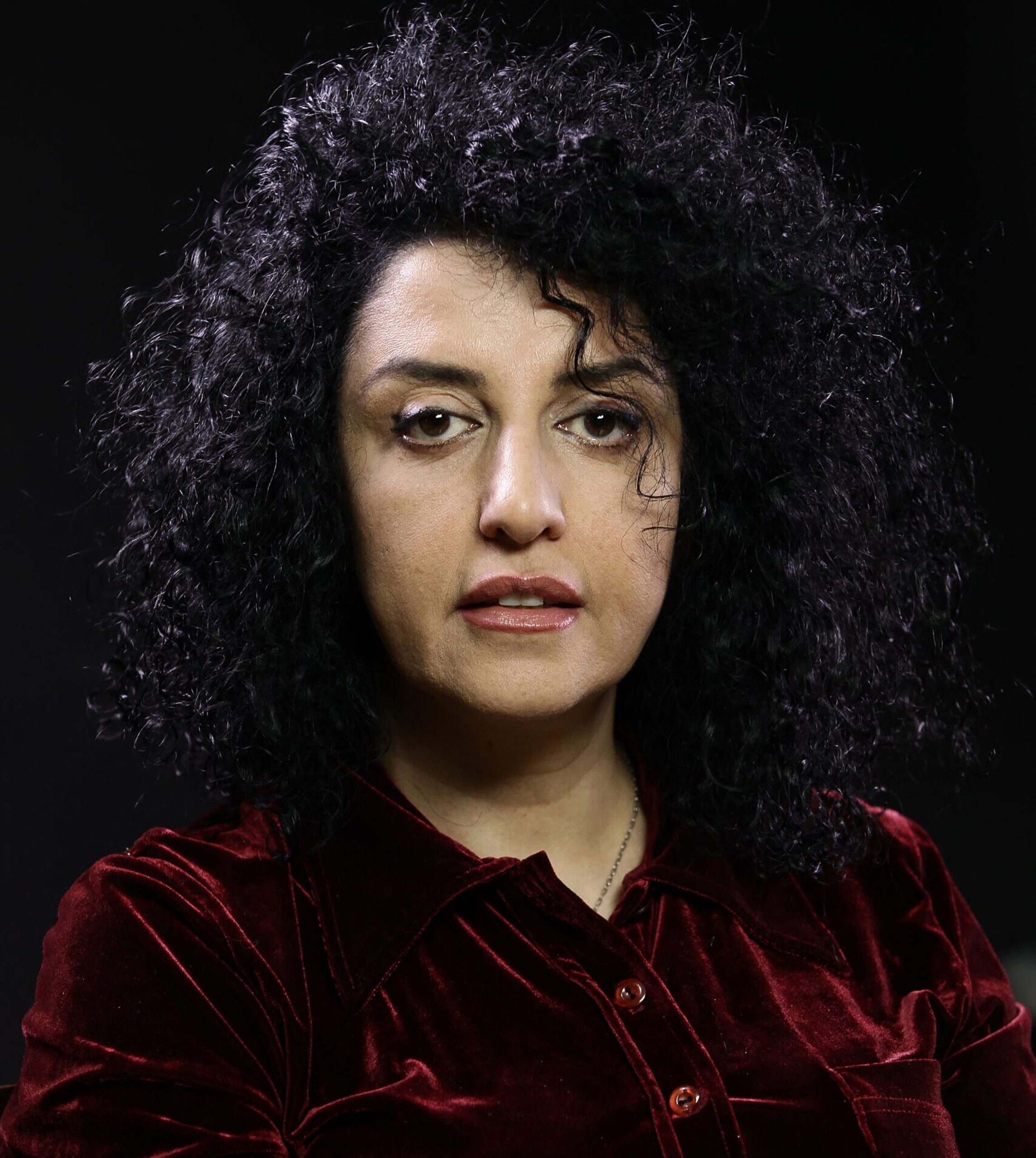 A portrait of Narges Mohammadi looking into the camera