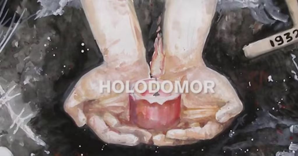 En målning med händer och texten Holodomor.
